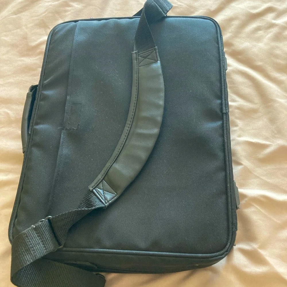 Gently used laptop bag in black nylon with several compartments.